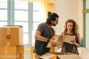 couple unpacking a box in their new apartment