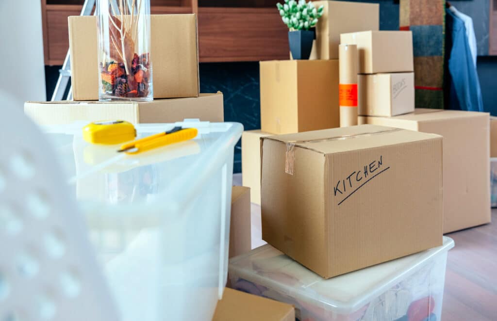 Large living room with stack of moving boxes