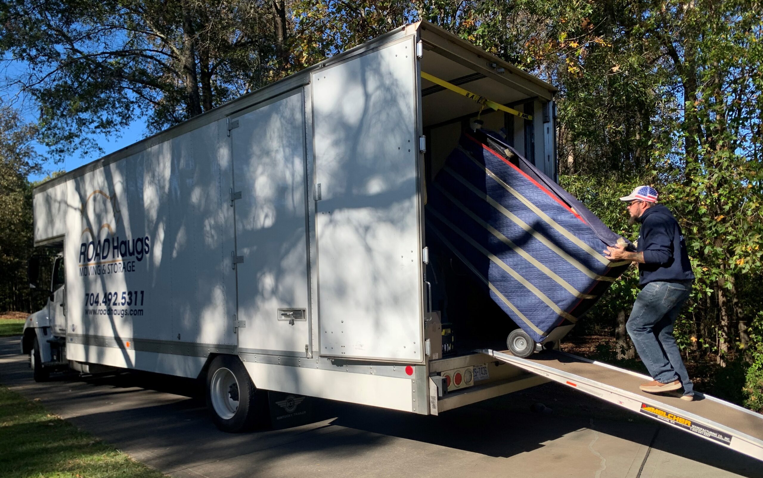 Road Haugs mover loading a moving truck, preparing for a relocation or home move.